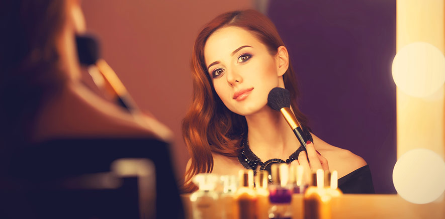 Woman applying makeup after microneedling